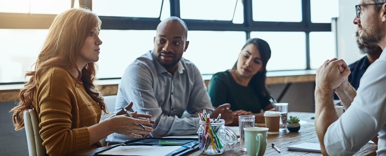 Group of people sitting around a conference table