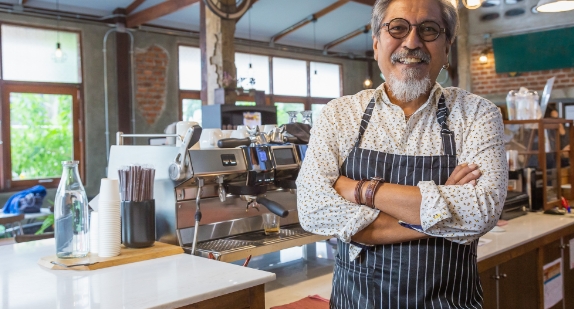 Coffee shop standing behind counter