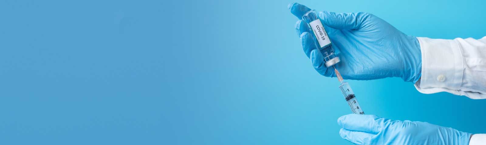 bnr_homepage A doctors gloved hands filling syringe with covid-19 vaccine