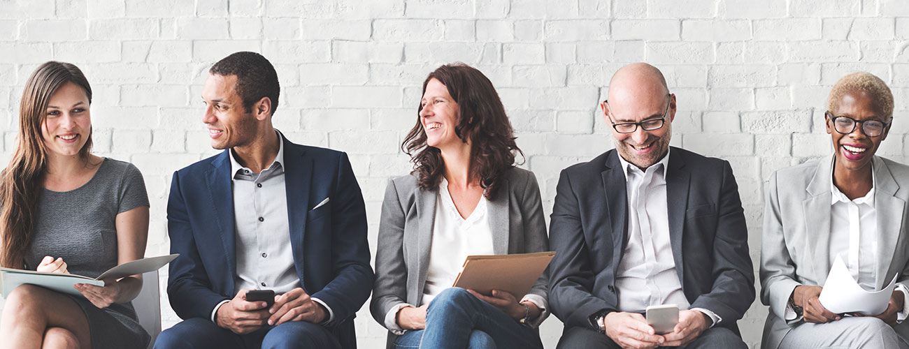 bnr-lookingforinsurance business dressed people sitting along wall