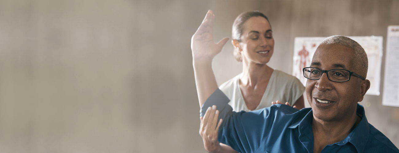 Physical therapist helping patient